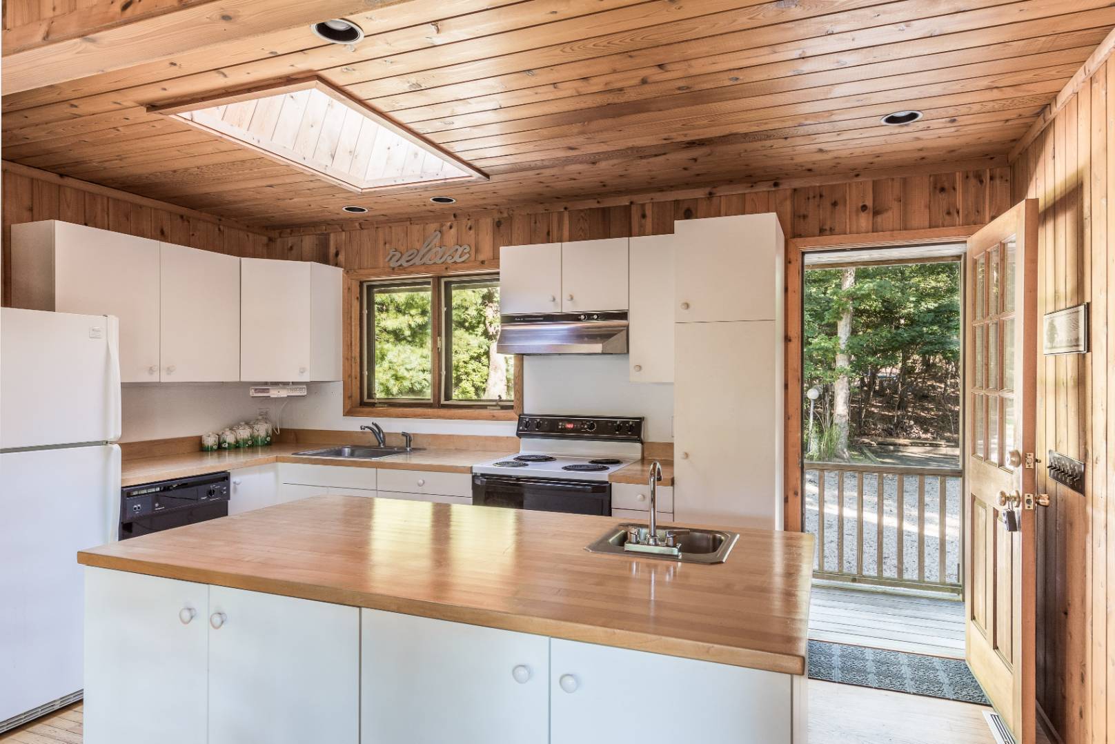 72 Fenmarsh Road East Hampton, NY 11937 - Photo 6 of 20 a kitchen with kitchen island white cabinets and white appliances