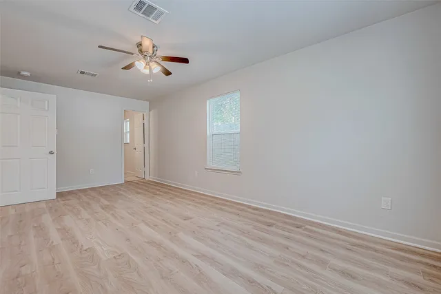 wooden floor in an empty room with a window