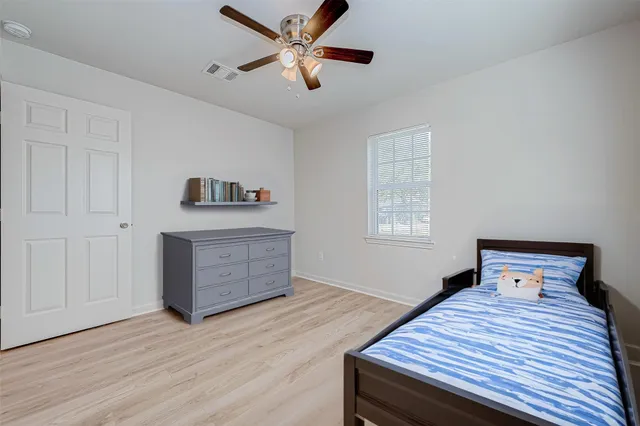 a bedroom with a bed and a dresser