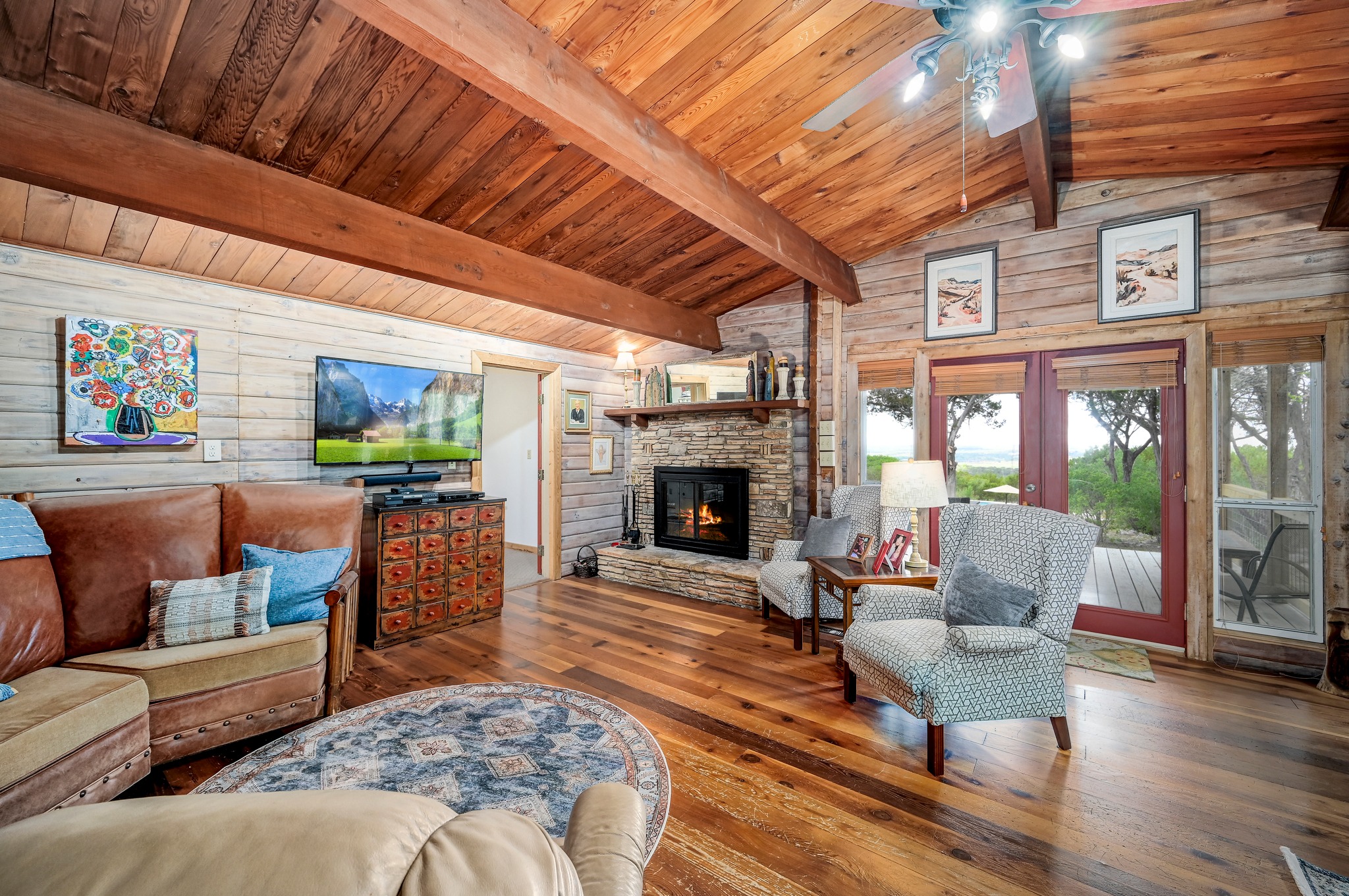 900 Box Canyon Road Wimberley, TX 78676 - Photo 6 of 40 Living room with wood burning fireplace and vaulted ceilings.