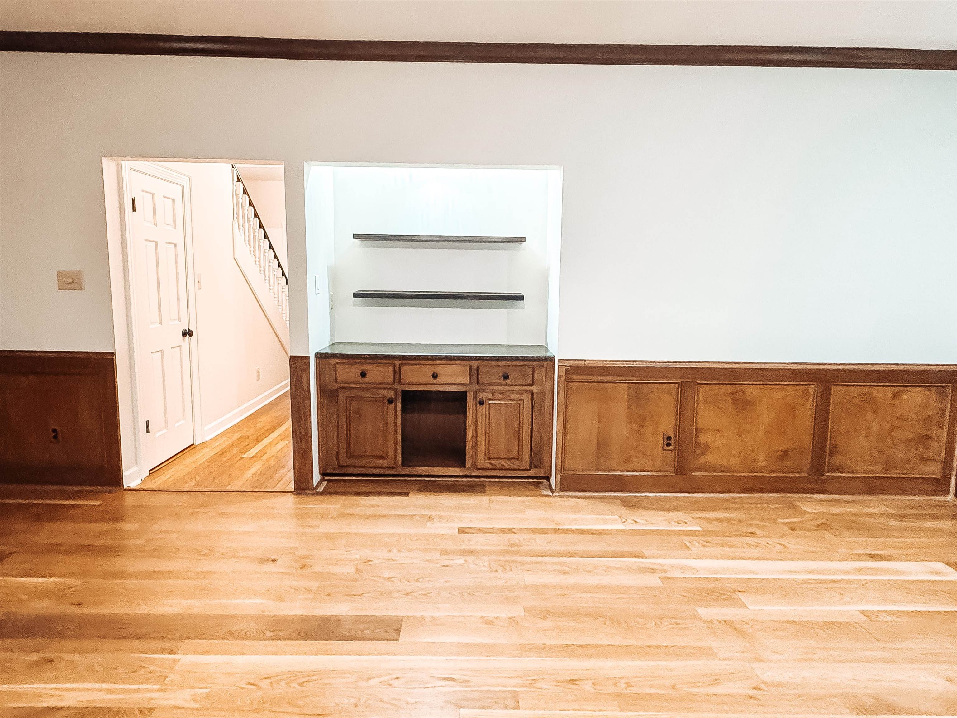 832 South Tree Drive Collierville, TN 38017 - Photo 18 of 40 Hardwood flooring throughout featuring a built-in cabinet with a stone-finish countertop and floating shelves