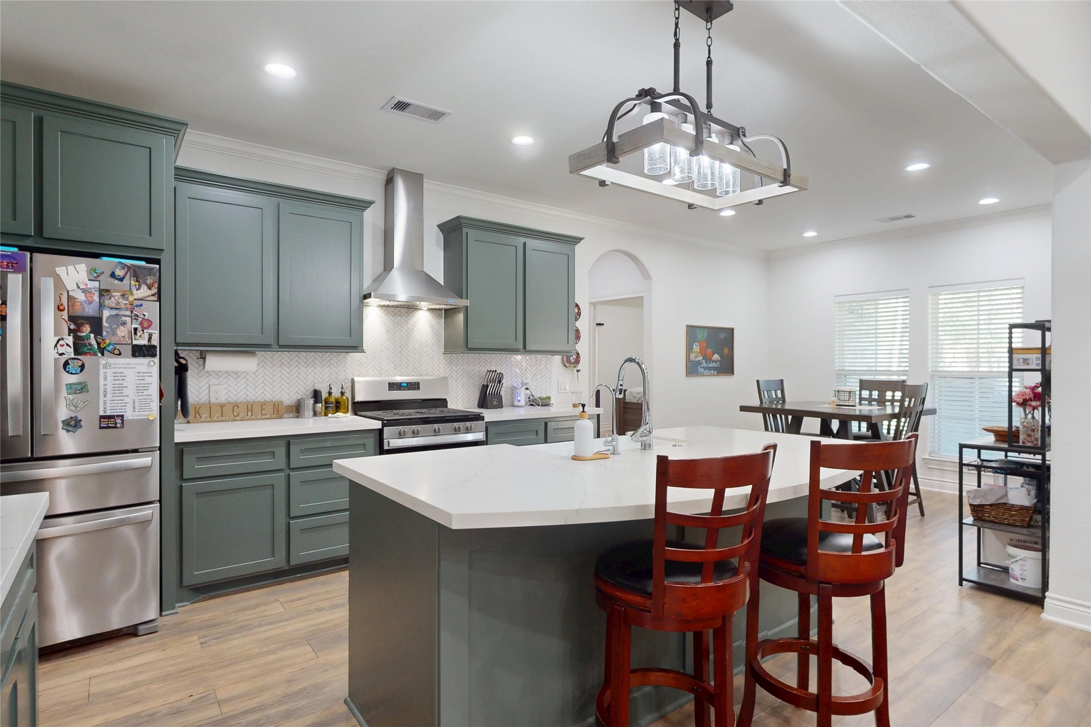 7815 Timber Switch Road Cleveland, TX 77328 - Photo 12 of 40 a kitchen with a dining table chairs stainless steel appliances and cabinets