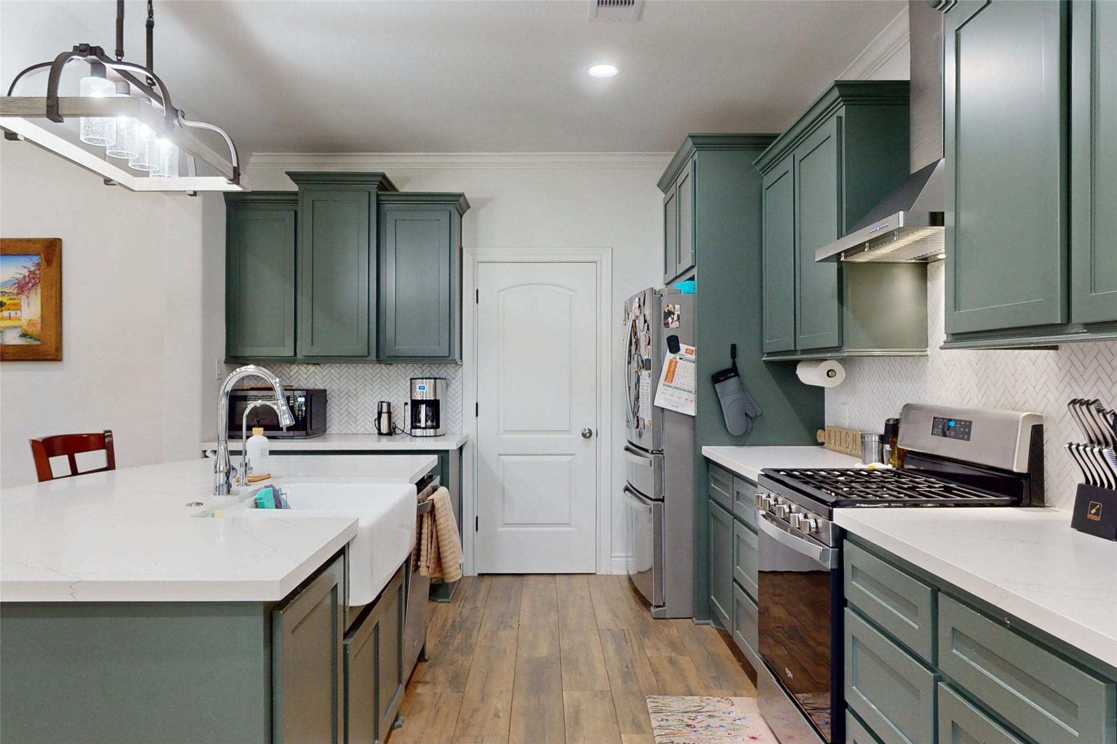 7815 Timber Switch Road Cleveland, TX 77328 - Photo 14 of 40 a kitchen with stainless steel appliances a sink stove refrigerator and cabinets