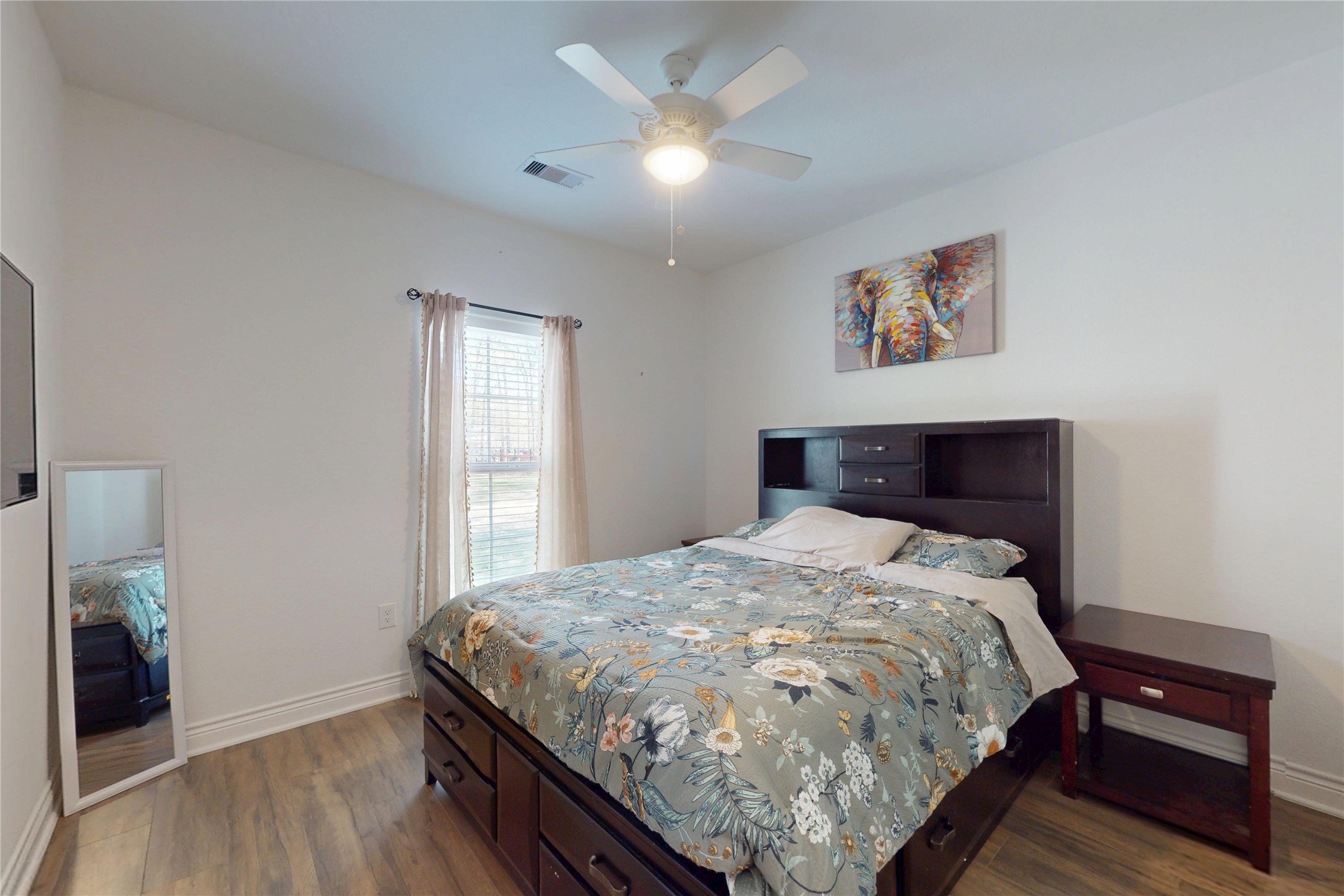 7815 Timber Switch Road Cleveland, TX 77328 - Photo 25 of 40 a bed sitting in a bedroom next to a window