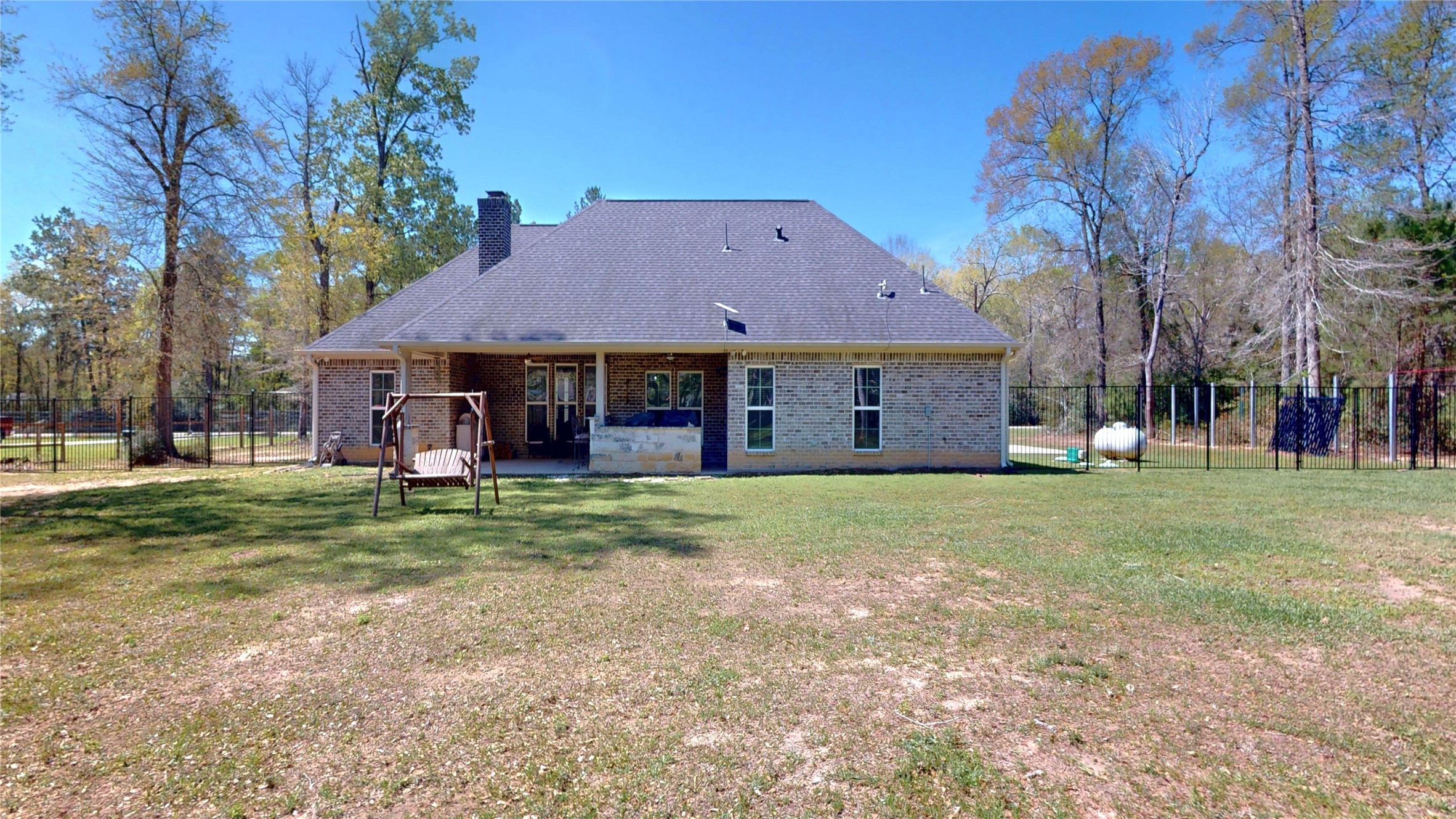 7815 Timber Switch Road Cleveland, TX 77328 - Photo 40 of 40 a view of a big house with a big yard and large trees