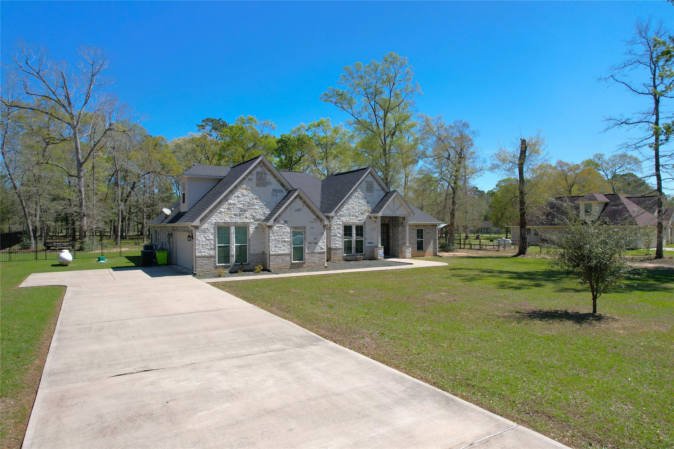 7815 Timber Switch Road Cleveland, TX 77328 - Photo 5 of 40 a front view of a house with a yard and trees