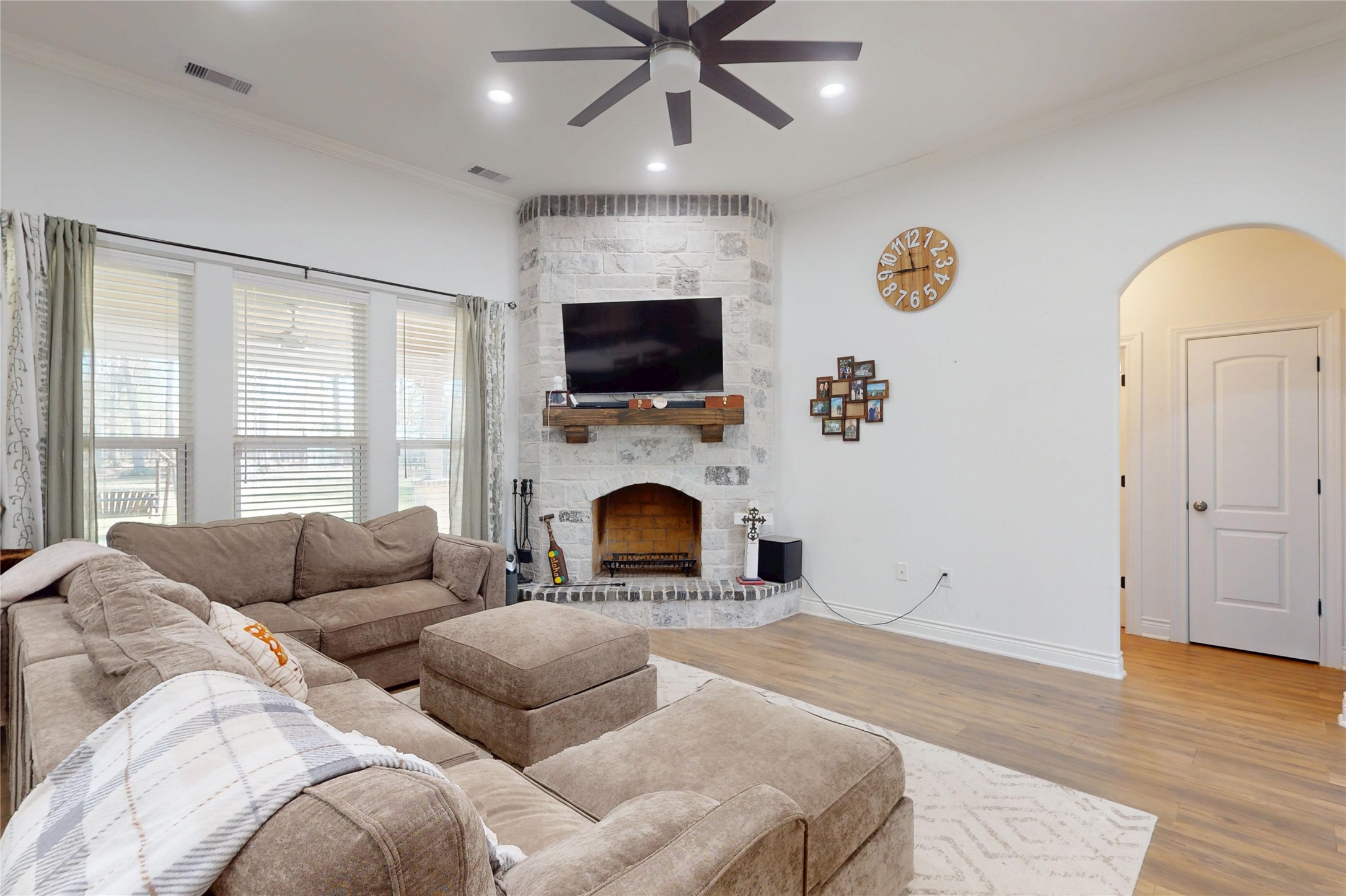 7815 Timber Switch Road Cleveland, TX 77328 - Photo 10 of 40 a living room with furniture a flat screen tv and a fireplace