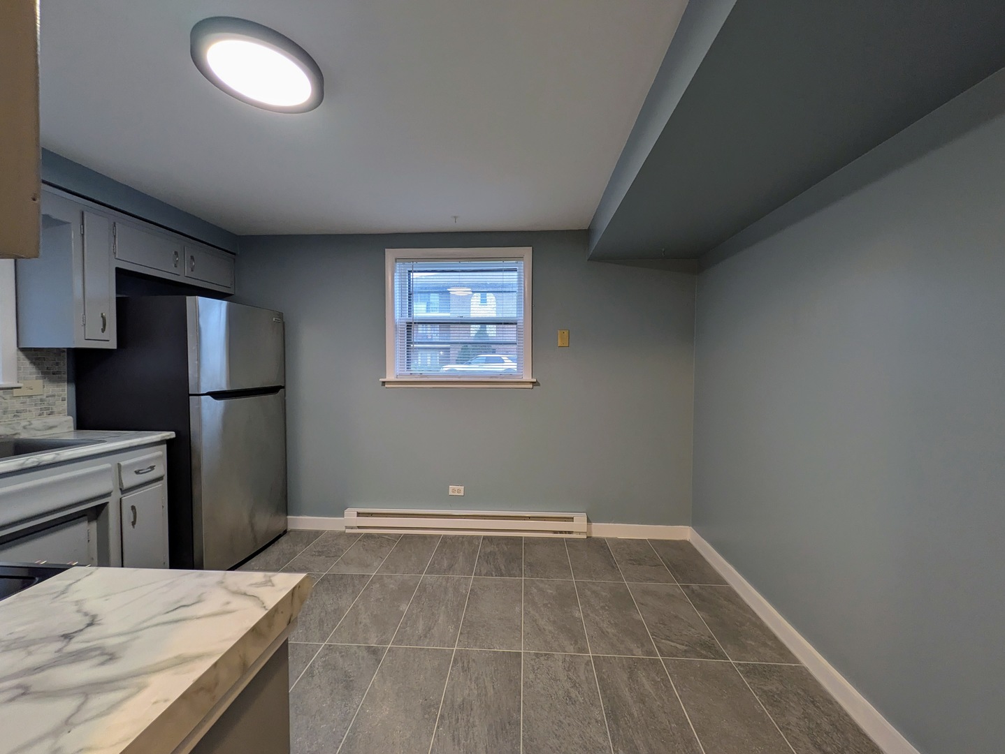 11840 South Karlov Avenue, Unit BE Alsip, IL 60803 - Photo 4 of 10 a room with a bed and a refrigerator