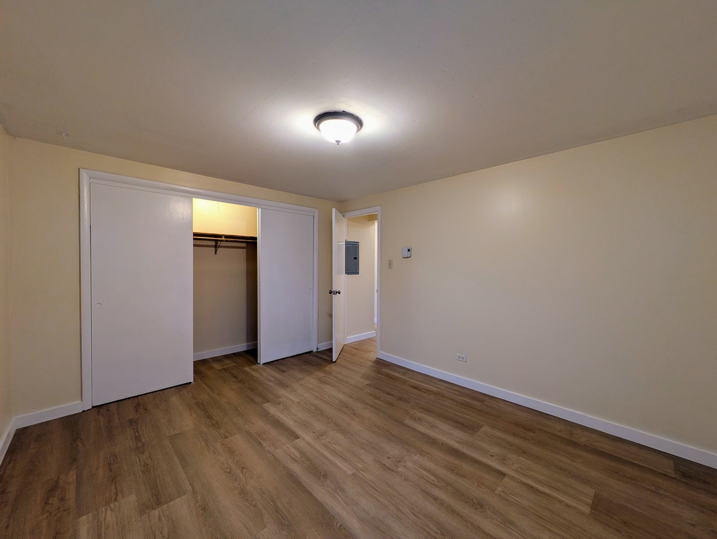 11840 South Karlov Avenue, Unit BE Alsip, IL 60803 - Photo 9 of 10 a view of an empty room with wooden floor and closet