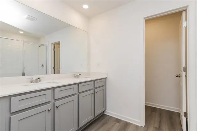 a bathroom with a double vanity sink and mirror