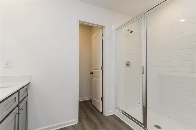 a bathroom with a shower and a glass door
