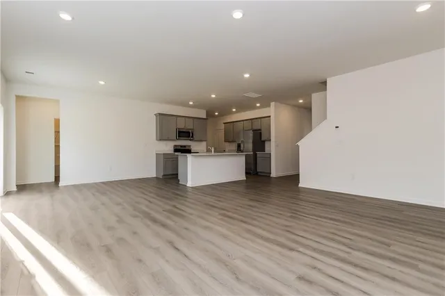 a view of a kitchen with a sink and a refrigerator
