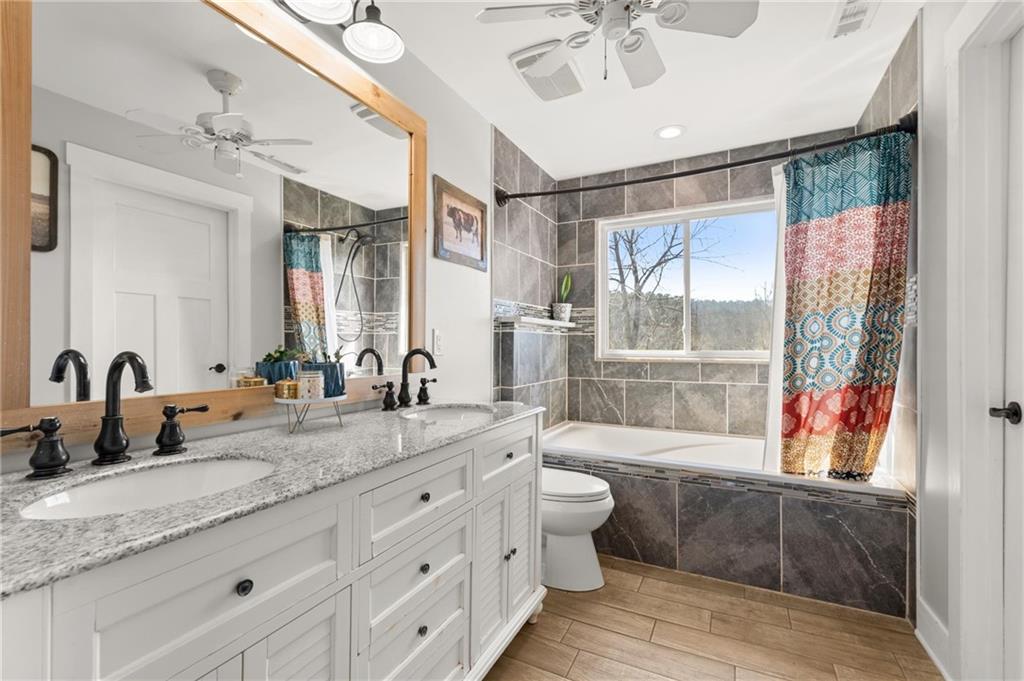 38 Hightower Road Talking Rock, GA 30175 - Photo 22 of 48 a bathroom with a granite countertop sink mirror and a bathtub