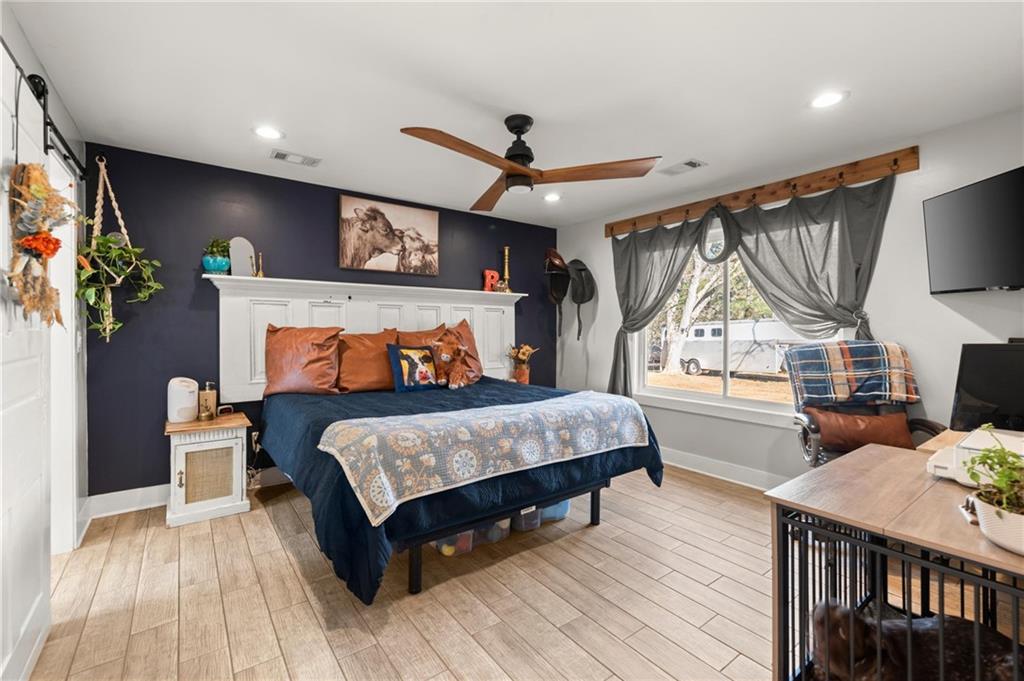 38 Hightower Road Talking Rock, GA 30175 - Photo 23 of 48 a bedroom with a bed a flat screen tv and paintings on the wall