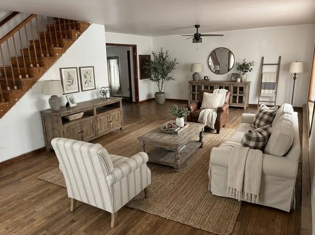 a living room with furniture a clock and wooden floor
