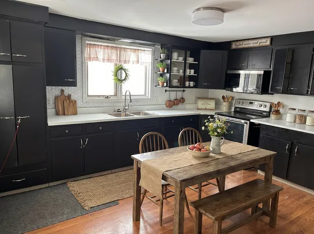 a kitchen with a dining table and chairs