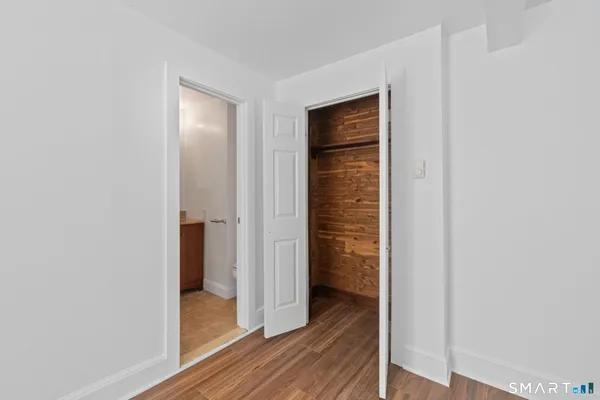 a view of a hallway with wooden floor