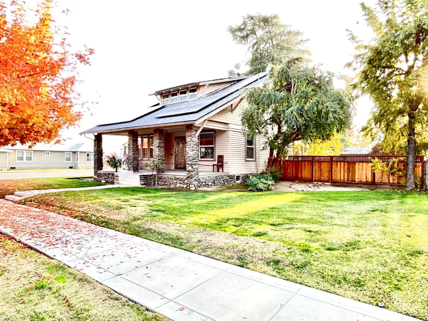 859 F Street Reedley, CA 93654 - Photo 27 of 28 a view of a house with a big yard and large trees