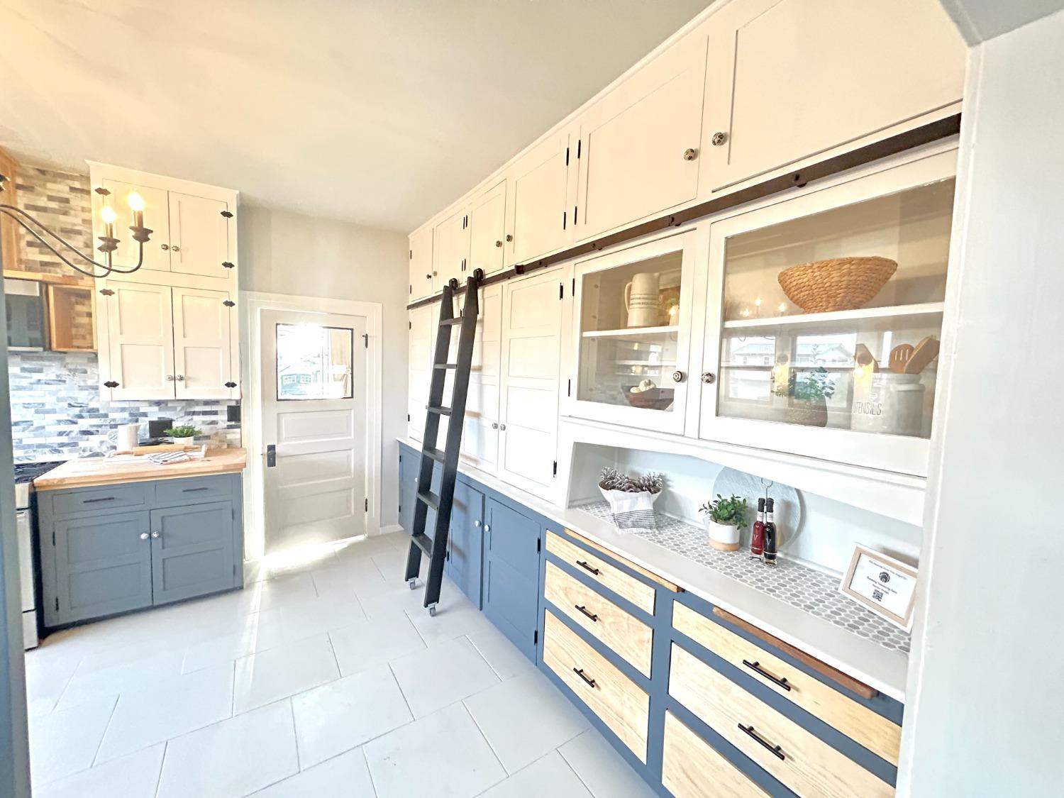 859 F Street Reedley, CA 93654 - Photo 9 of 28 a kitchen with refrigerator and cabinets