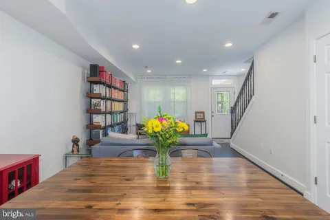 a living room with furniture and a book shelf