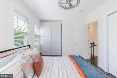 a bedroom with a large bed and a chandelier