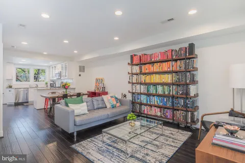 a kitchen with stainless steel appliances granite countertop a sink dishwasher and a stove with wooden floor