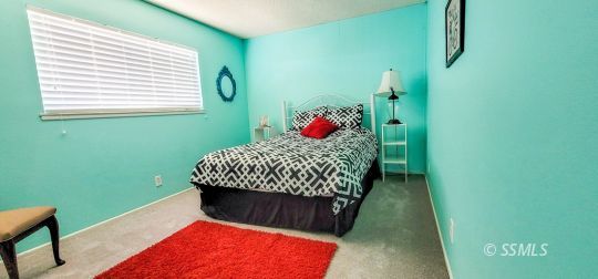 548 South Sanders Street Ridgecrest, CA 93555 - Photo 23 of 29 a living room with a bed and a window