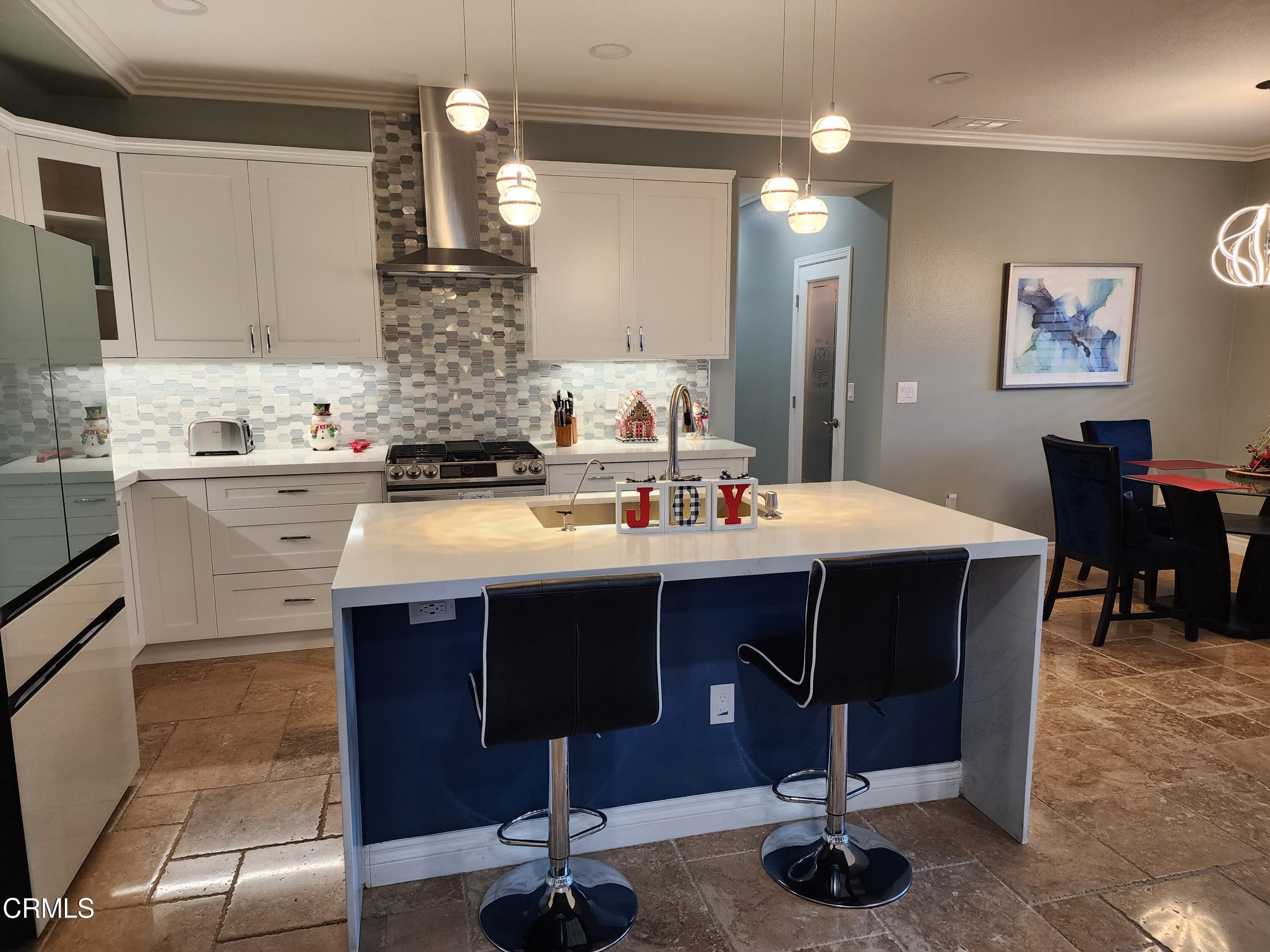 998 Arrasmith Lane Fillmore, CA 93015 - Photo 14 of 40 a kitchen with a sink dining table and chairs