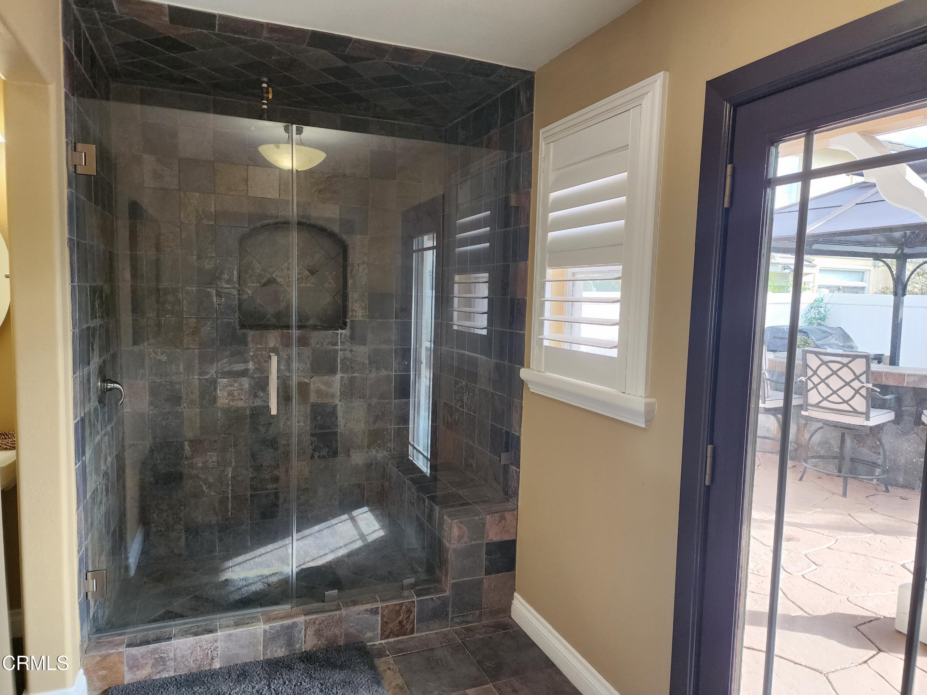 998 Arrasmith Lane Fillmore, CA 93015 - Photo 18 of 40 a bathroom with a glass shower door and a window