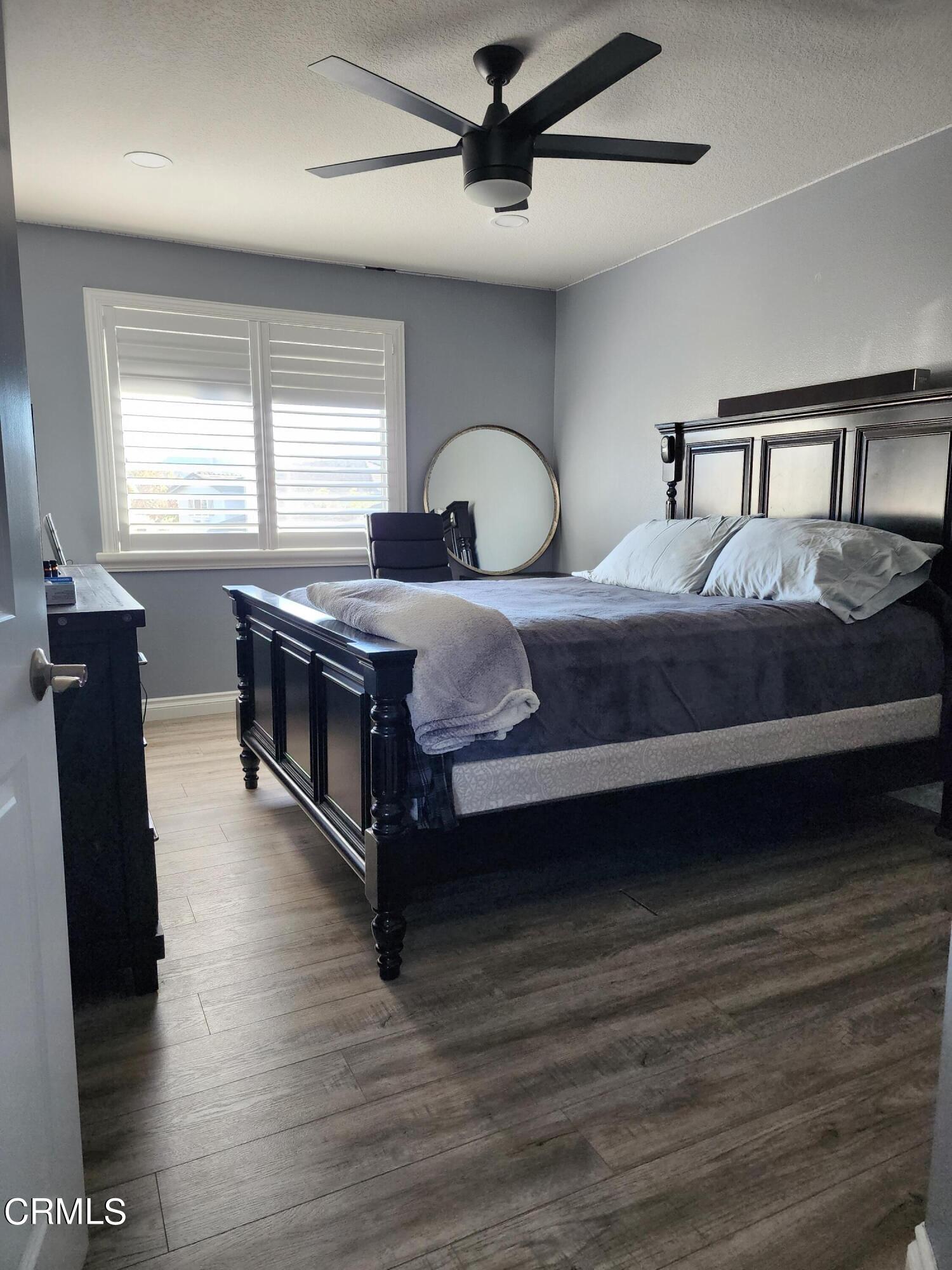 998 Arrasmith Lane Fillmore, CA 93015 - Photo 21 of 40 a bedroom with a bed and wooden floor