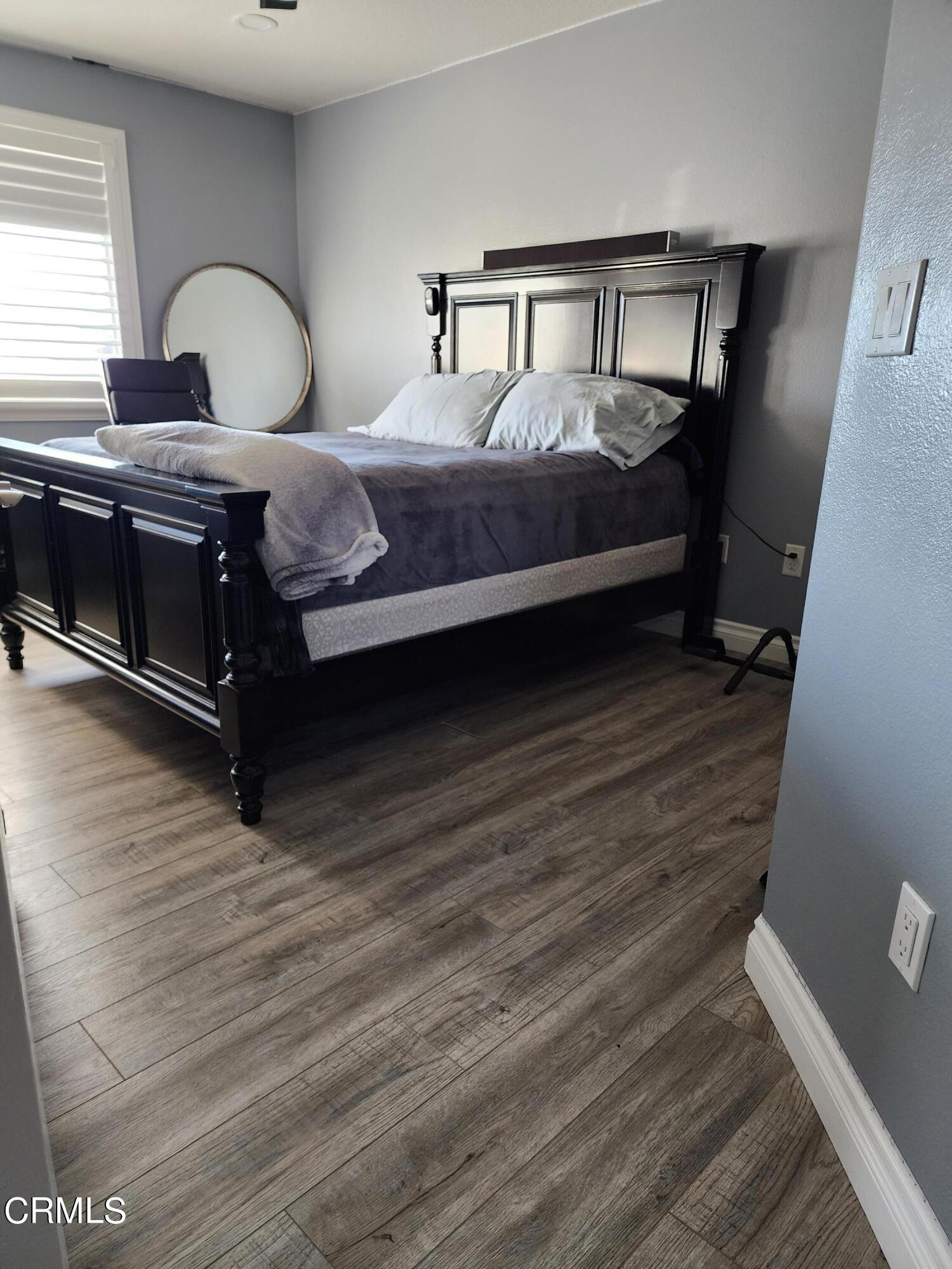998 Arrasmith Lane Fillmore, CA 93015 - Photo 33 of 40 a bedroom with a bed and a dresser with wooden floor
