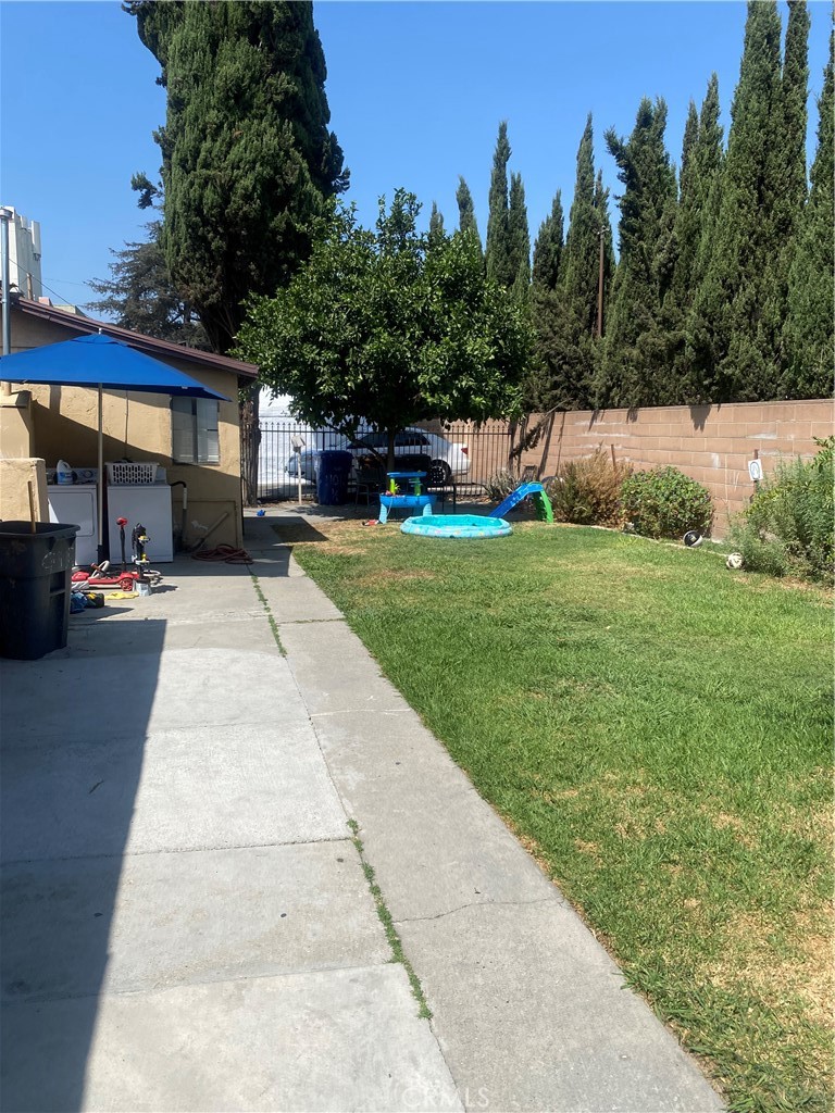 11016 Concert Street El Monte, CA 91731 - Photo 10 of 22 a view of a patio with a table and chairs under an umbrella