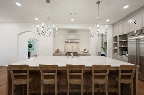 a large kitchen with a table and chairs