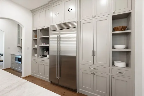a kitchen with cabinets and stainless steel appliances