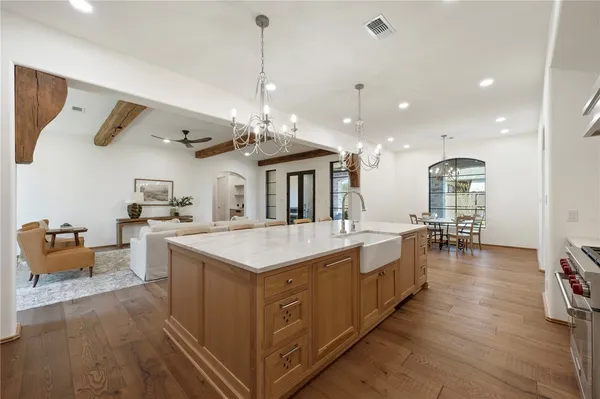 a large white kitchen with kitchen island lots of counter space