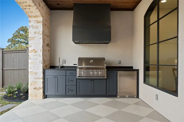 a living room with furniture and a view of kitchen