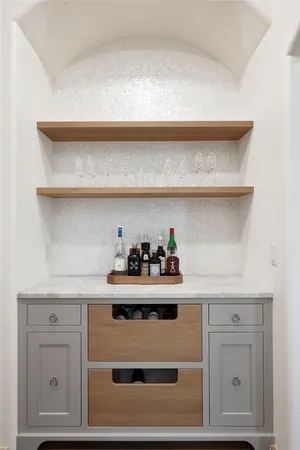 a bedroom with a large bed chandelier and a window