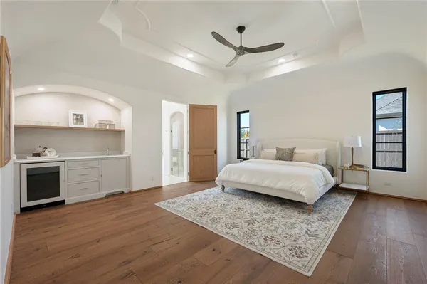 a bedroom with a bed and wooden floor