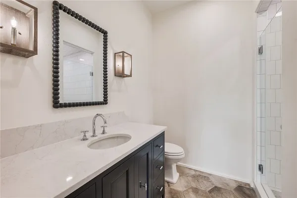 a bathroom with a sink a toilet and a mirror