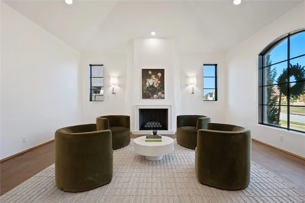 a living room with furniture potted plant a fireplace and a window
