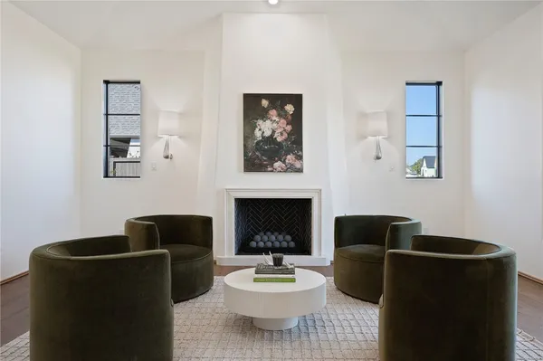 a living room with furniture a fireplace and a wall painting