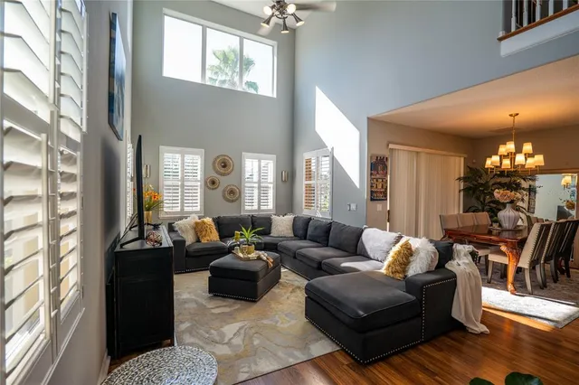 a living room with furniture and a chandelier