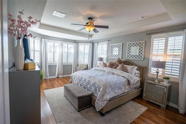 a bedroom with a large bed and a chandelier
