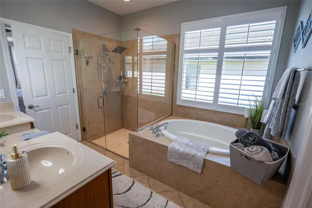 a bathroom with a tub sink and mirror