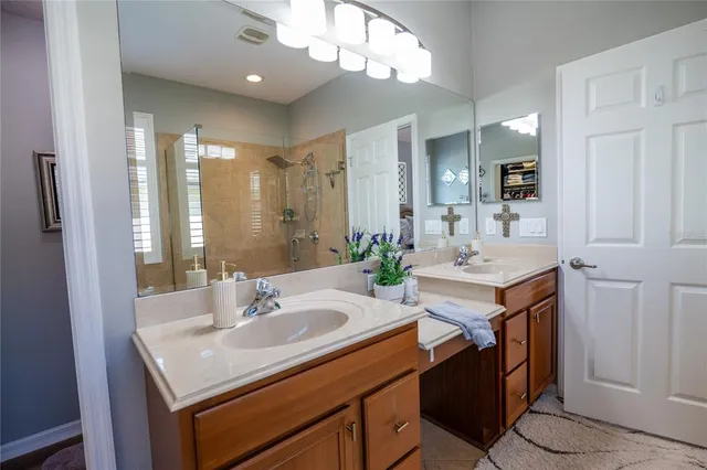 a bathroom with a sink double vanity and a mirror
