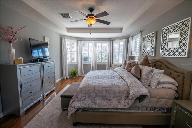 a bedroom with a bed and a chandelier