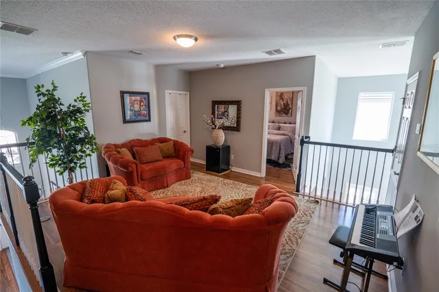 a living room with furniture and a potted plant