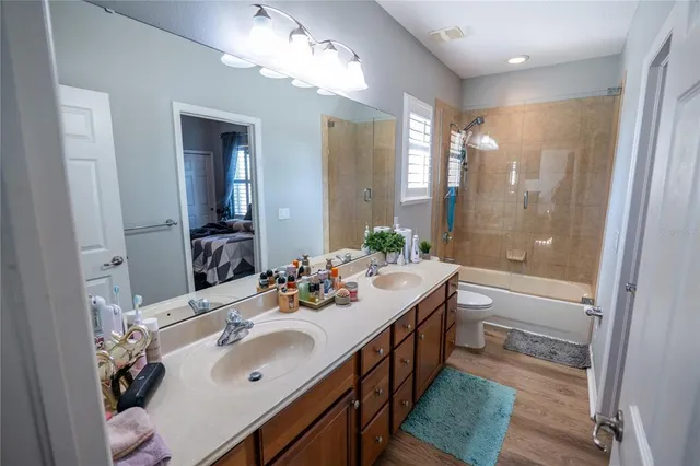 a bathroom with a sink vanity tub and shower
