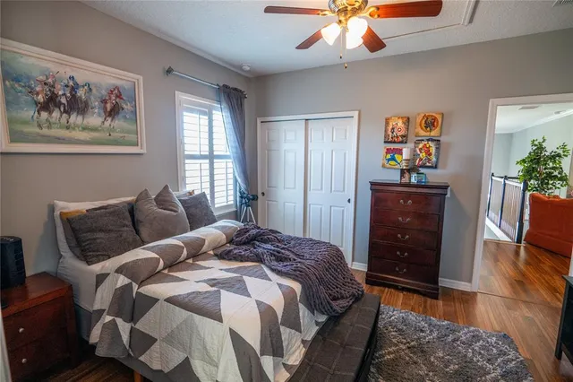 a bedroom with a bed and a chandelier