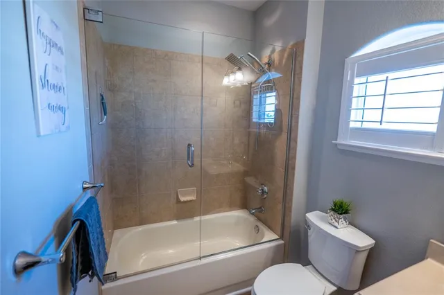 a bathroom with a bath tub a toilet and a shower